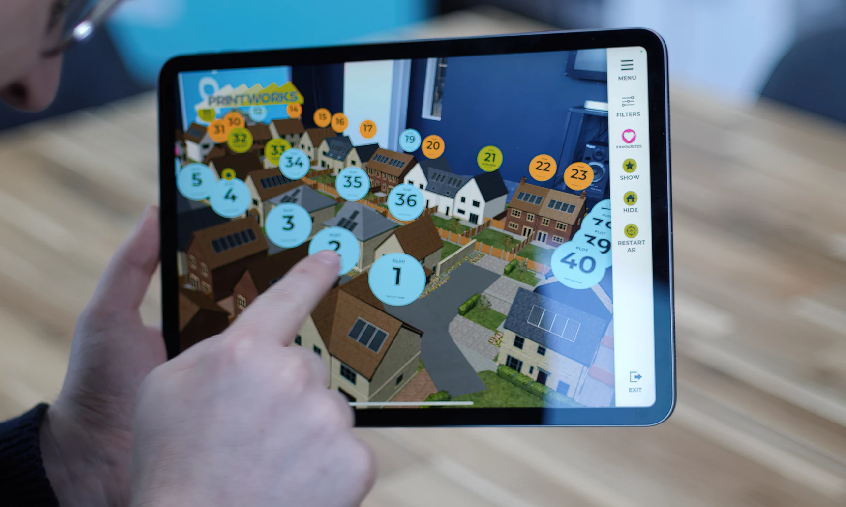 An ipad using the AR camera to view a housing development