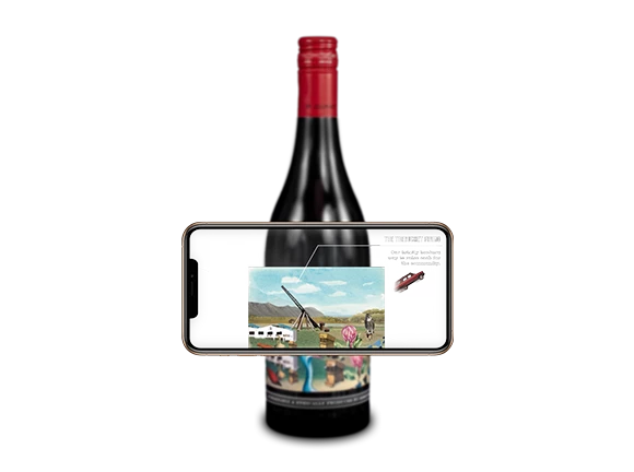 A wine bottle with a phone placed over the label to activate an Augmented Reality game