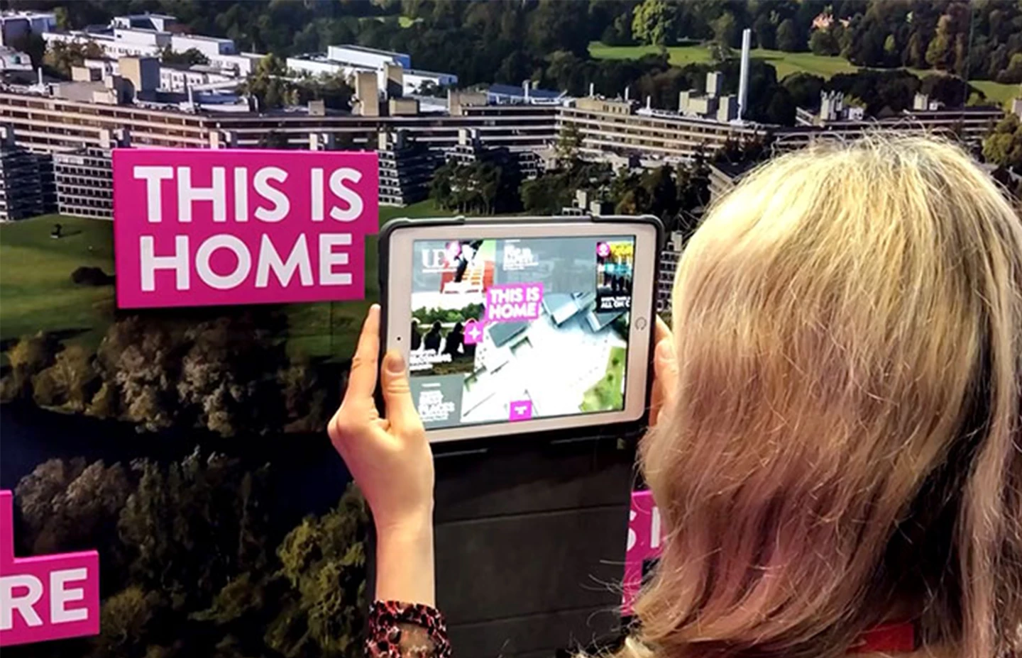 a woman using an ipad to activate an augmented reality experience