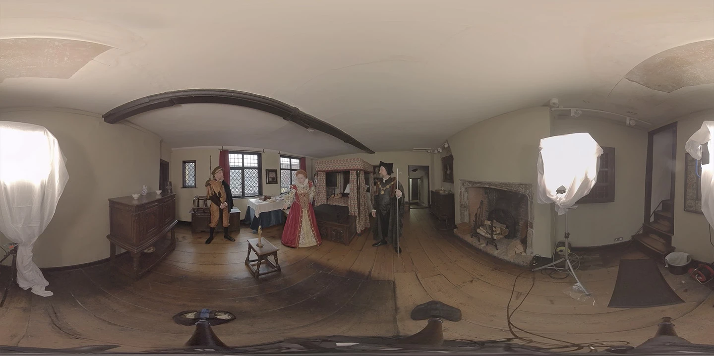 Elizabeth the First flanked by servants in a bedroom