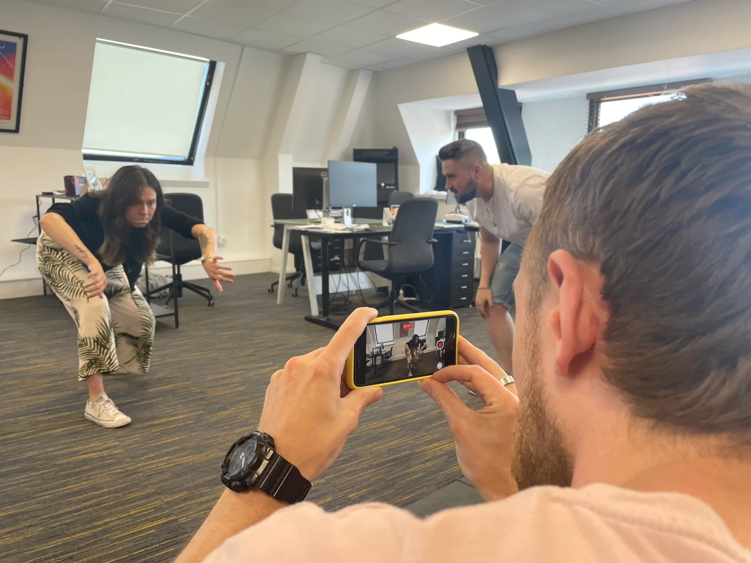 a man filming people acting on a phone