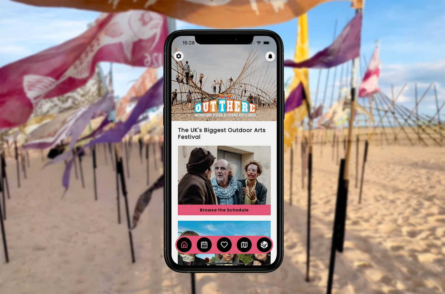 Out There Festival app shown on device in front of Beach of Dreams Installation