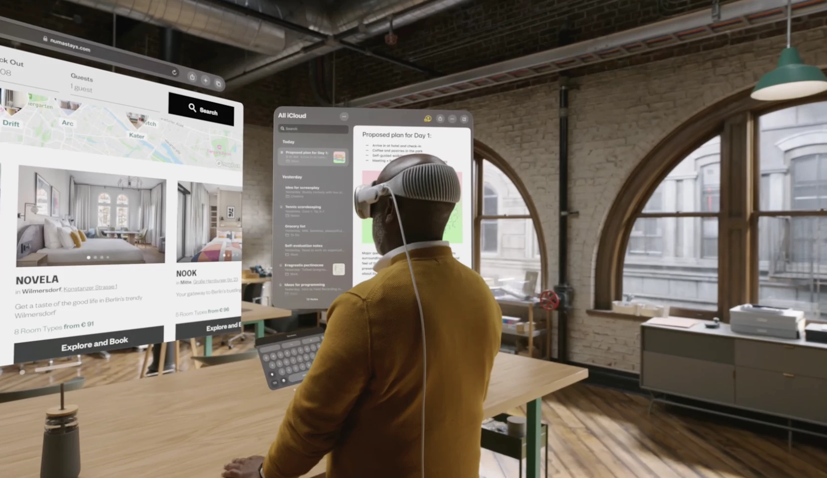 a man using the Apple vision pro to do work in an office