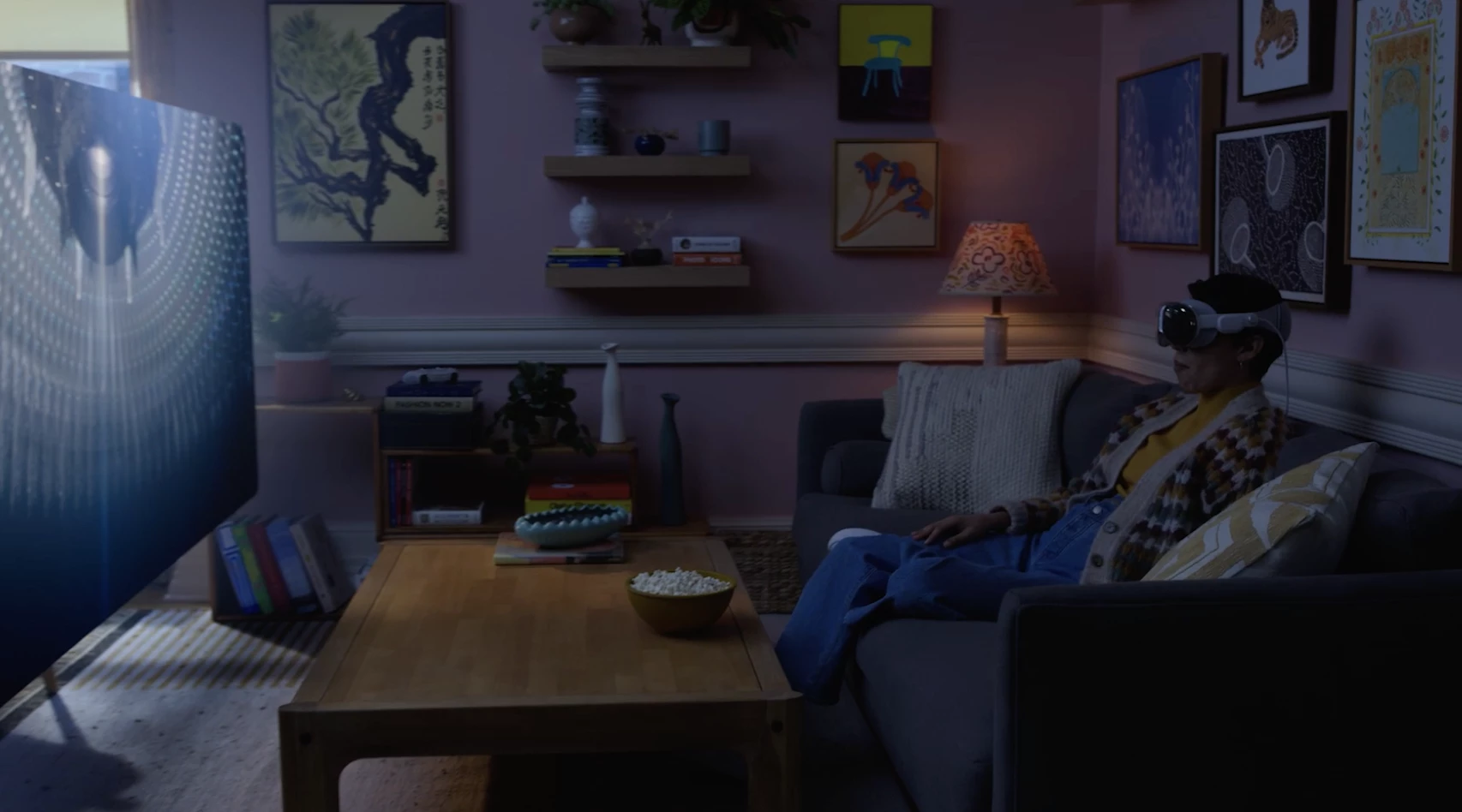 a woman using the apple vision pro to watch a movie sat on a sofa