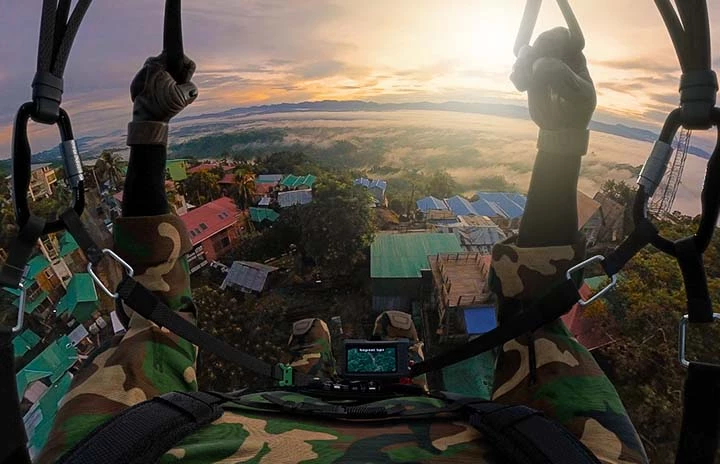 a pov shot of a paraglider landing in Bangladesh